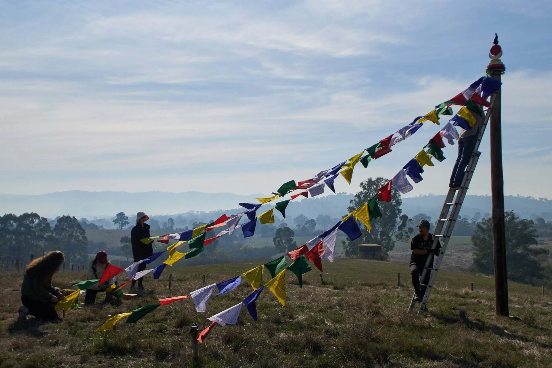 volunteers-at-land-of-shambhala Volunteers hanging flags at land of shambhala